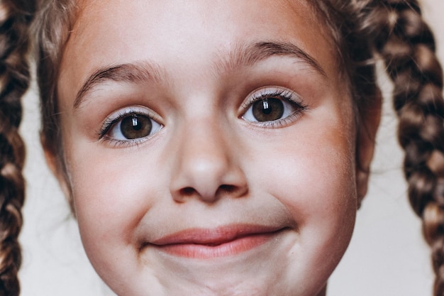 Funny face of cute young girl Portrait of Pretty little girl with pigtails