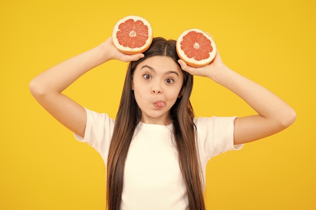 Funny face Happy teenager girl in tshirt hold grapefruit orange kids fruits vitamin