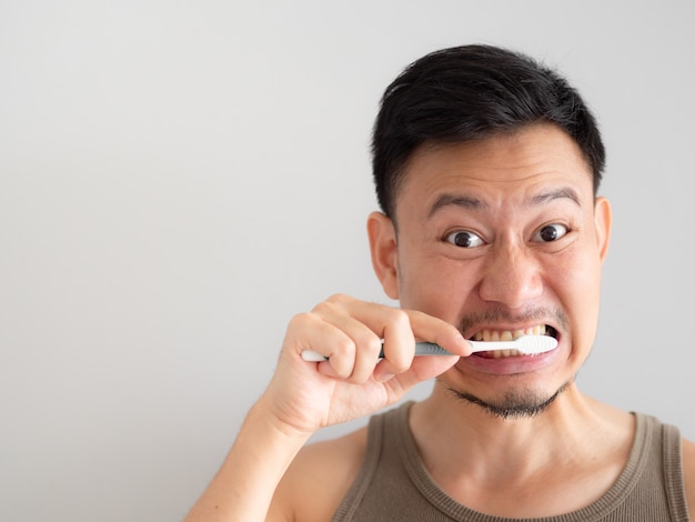 Funny face man brush his teeth without foam.