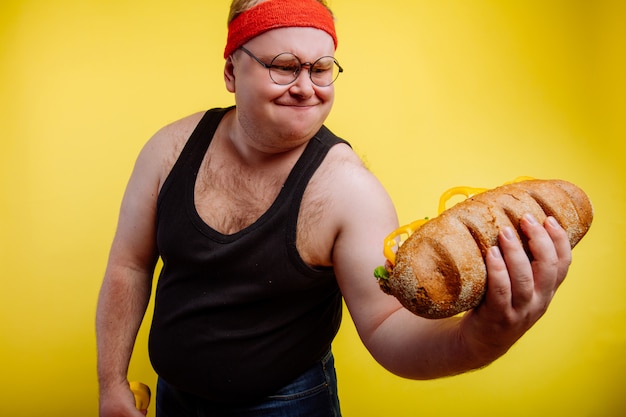 Funny fat man sweats while lifting burger