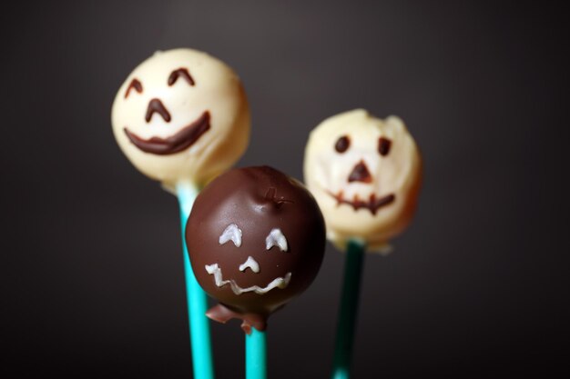 Funny Halloween cake pops on dark background