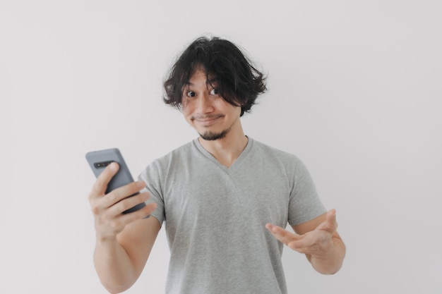 Funny and happy face of man look at his smartphone on white background