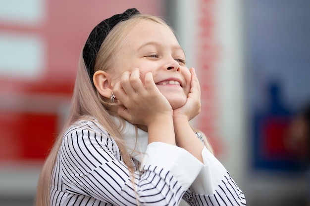 Funny little blonde girl smiles beautifully A rado child