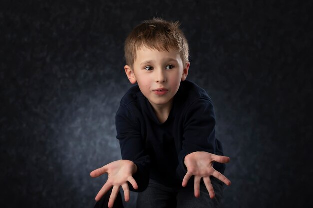 Funny little boy shows his handsChild at four years old