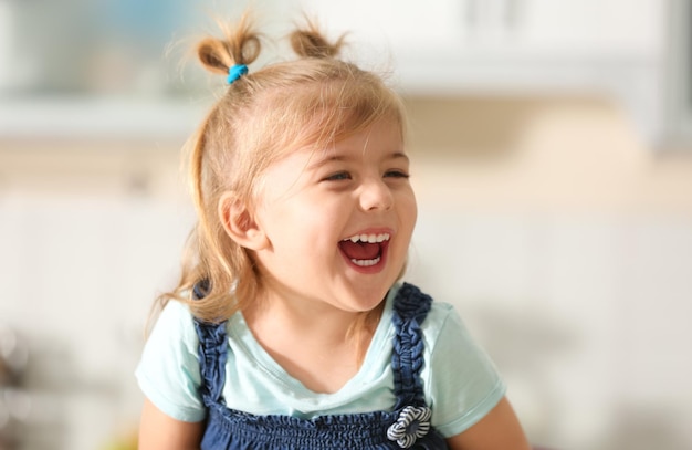 Funny little girl smiling indoors