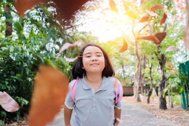 Funny little girl in the summer on nature little girl has happy fun with cheerful smiling face