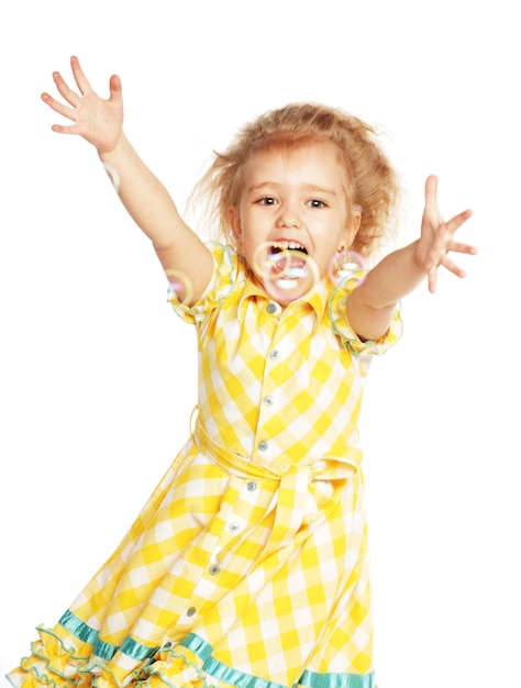 Funny lovely little girl with soap bubbles