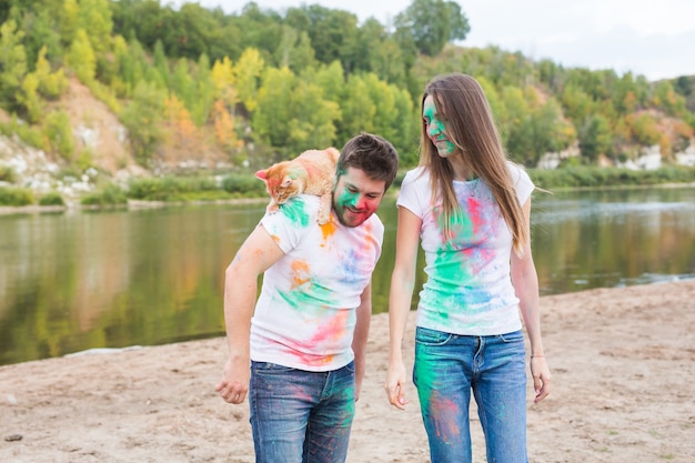 Funny man and woman with cat on natural