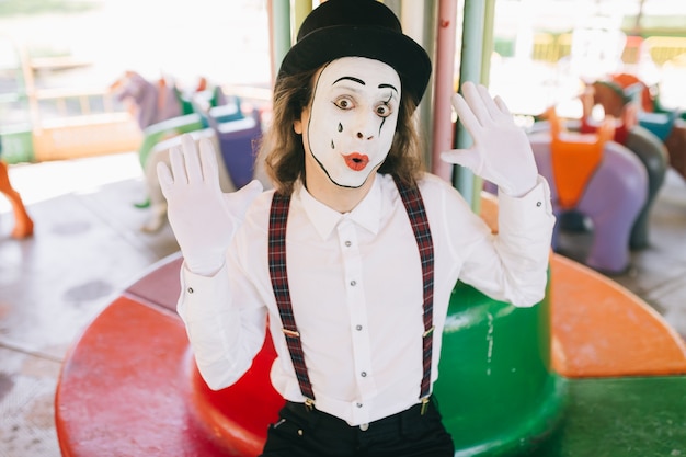 Funny mime in a carousel