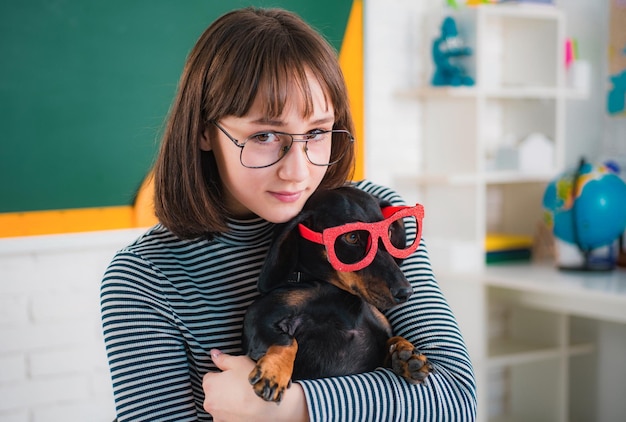 Funny puppy in glasses teenager girl with puppi happy smiling teenager girl go back to school funny