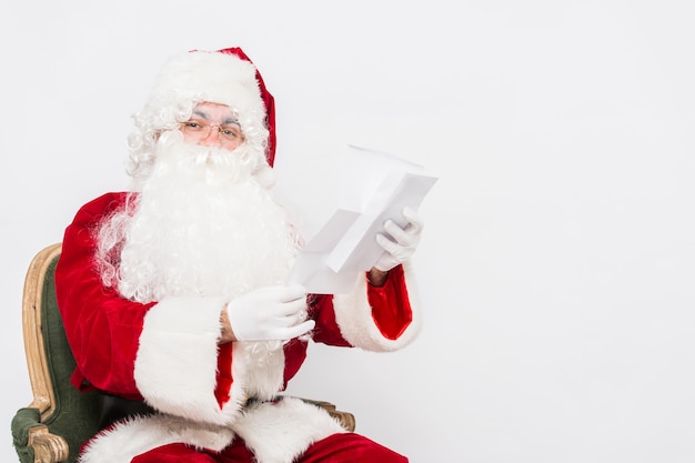 Funny Santa Claus in a red costume with a letter