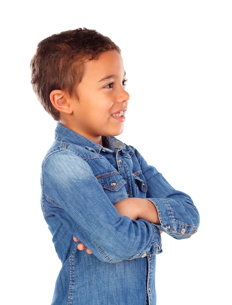 Funny small child with dark hair and black eyes crossing his arms 