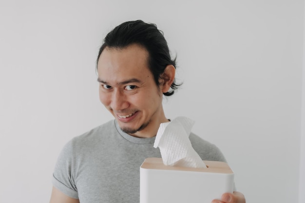 Funny smile face of man holding tissue in concept of self satisfied