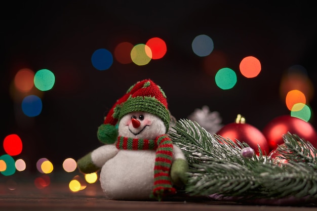 Funny snowman on a Christmas evening background. photo with a copy - space.