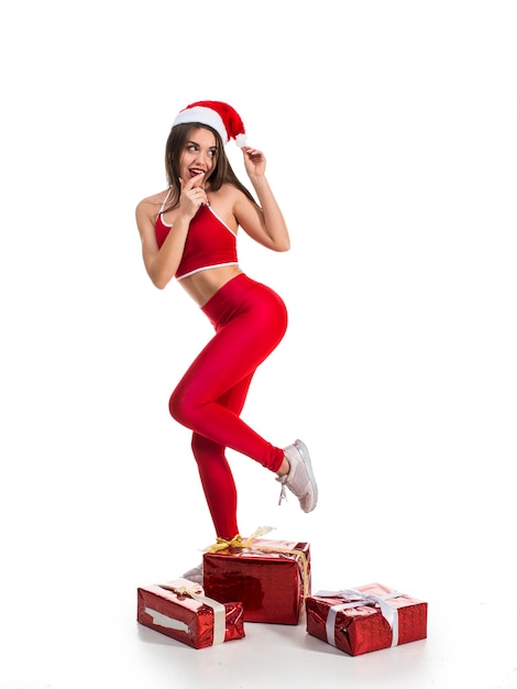 Funny sporty woman with new year and christmas gifts isolated on white background xmas fun and sport