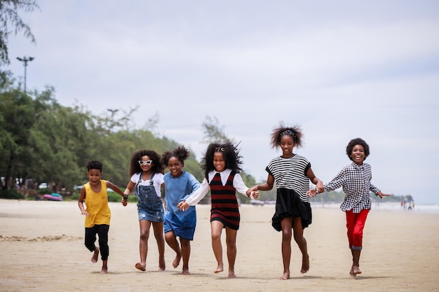 Funny vacation Children or kids playing and romp together at the beach on holiday