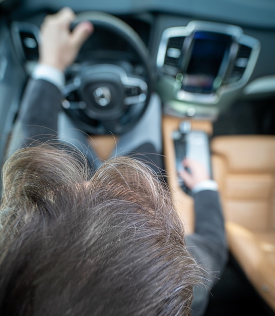 Funny wide angle of a male driver in luxury car