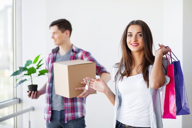 Funny young couple enjoy and celebrating moving to new home. 