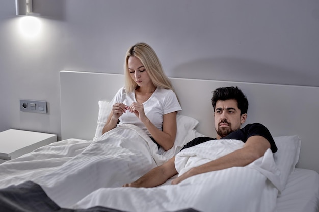 Furious Caucasian Woman And Man During Argue At Home Sitting On Bed Not Talking