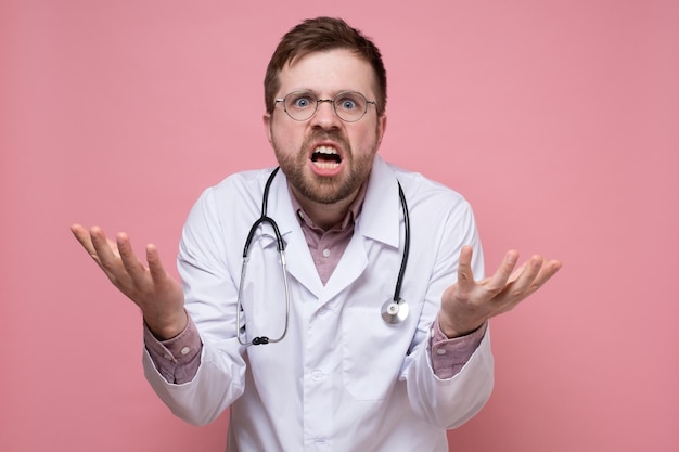 Furious surprised doctor makes a questioning and bewildered gesture with hands