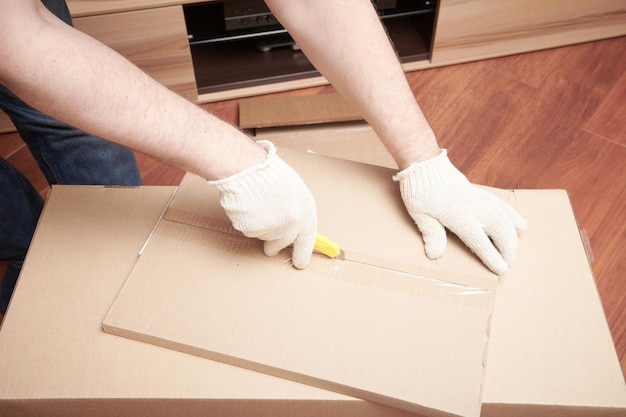 The furniture assembler unpack box with shelf for self assembling Furniture assembly process at home DIY Assembling Close up view