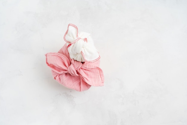 Furoshiki - Asian technique of fabric wrapped gifts. The linen cloth is knotted traditionally used to transport gifts.