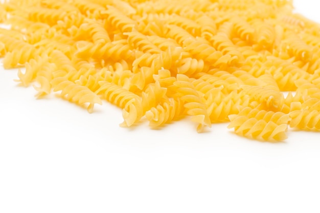 Fusilli pasta on a white background with copy space