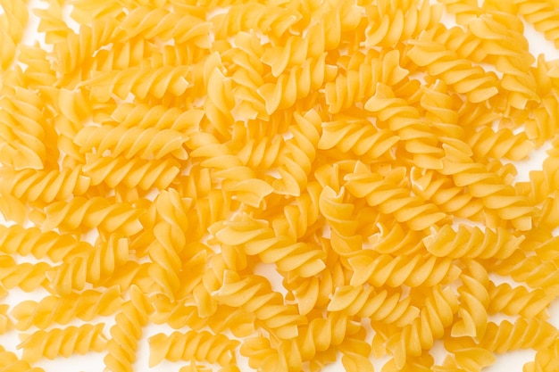 Fusilli pasta on a white background with copy space