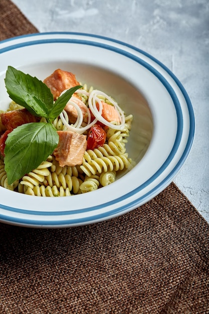 Fusilli pasta with baked salmon and spinach The concept of Italian cuisine classic Beautifully canned table with pasta