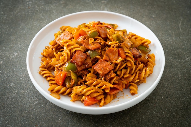 Fusilli pasta with ham and tomatoes sauce