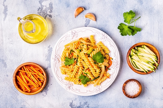 Fusilli pasta with squid, zucchini and carrots