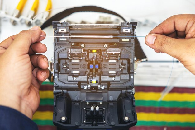 Photo fusion of fiber optics cable internet signal splicing and wire connection using equipment optical line welding machine optic fiber soldering isp engineer