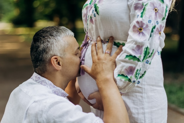 Future dad kissing belly of his pregnant wife