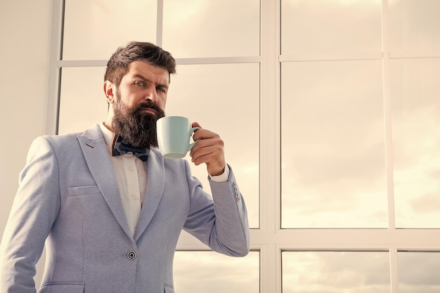 Future opportunities serious bearded man drink coffee businessman in formal outfit modern life confident business man at window future success morning inspiration copy space Future is now