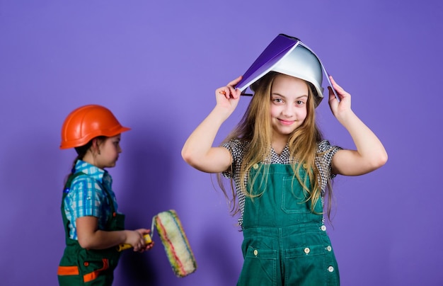 Future profession small girls repairing together in workshop Child care development Builder engineer architect Kid worker in hard hat Tools to improve yourself Repair Repairing home together