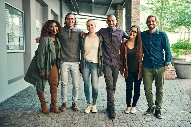 Future were ready for you Portrait of a group of happy young students standing together outdoors on campus