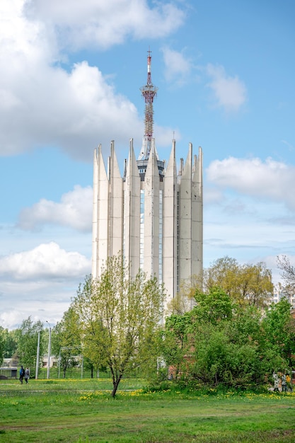 Futuristic architecture of a scientific building in a green summer park with a blue sky in saint pet