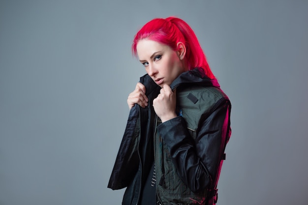 Futuristic fashion a young bright and attractive woman with pink hair