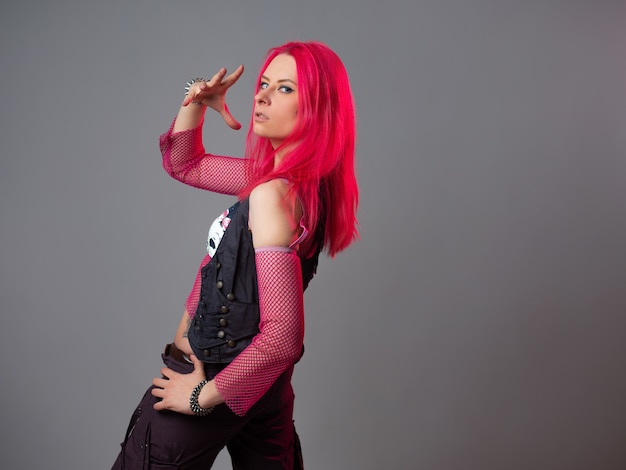 Futuristic fashion a young bright and attractive woman with pink hair