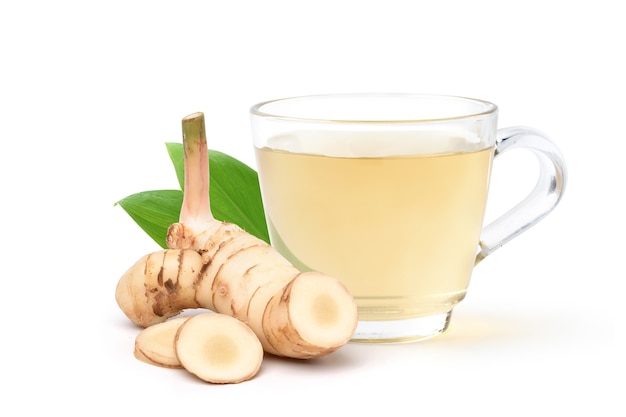 Galangal herbal beverage with fresh rhizomes slices solated on white background.