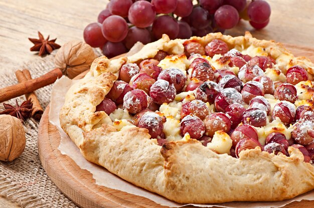 Galette with grapes and cheese sprinkled with powdered sugar