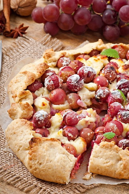 Galette with grapes and cheese sprinkled with powdered sugar