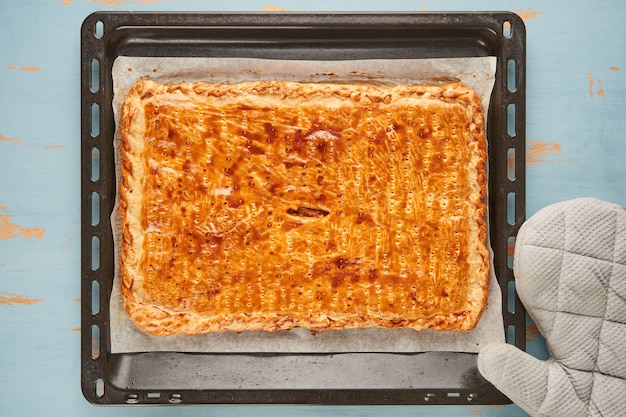 Galician freshly baked patty stuffed with tuna on a baking sheet