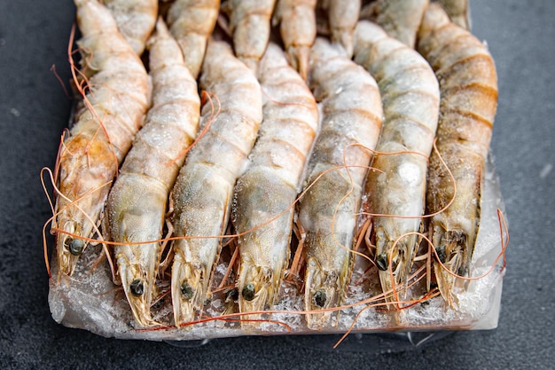 gambas raw frozen in ice big shrimp seafood prawn meal food snack pescatarian diet on the table