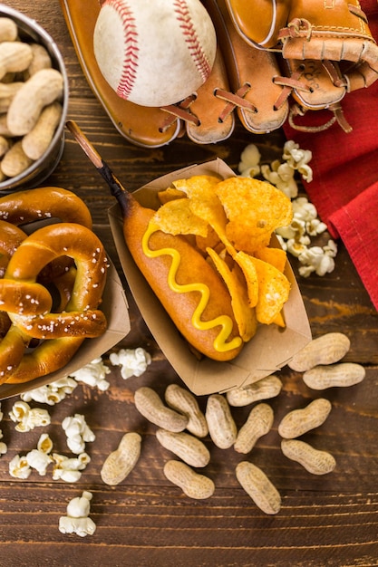 Game day traditional snacks included corndogs and salted peanuts on a wood board.