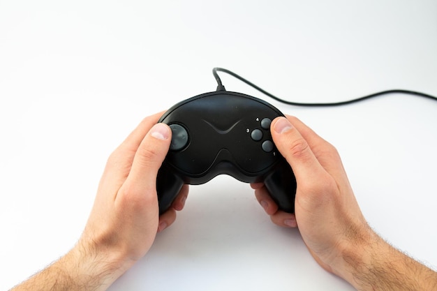 Game joystick in hand on a white background