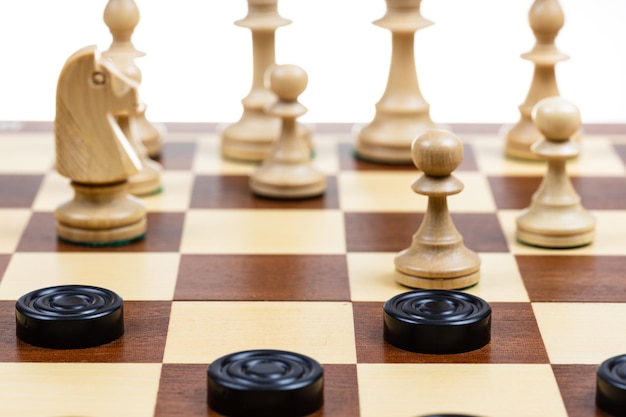 Gameplay of chess and checkers on board closeup