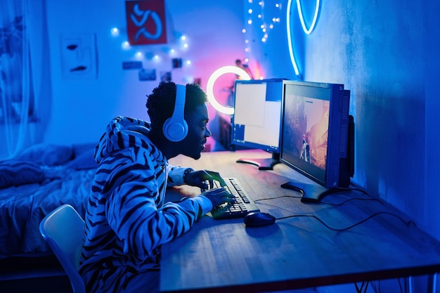 Gamer boy playing video game in the room