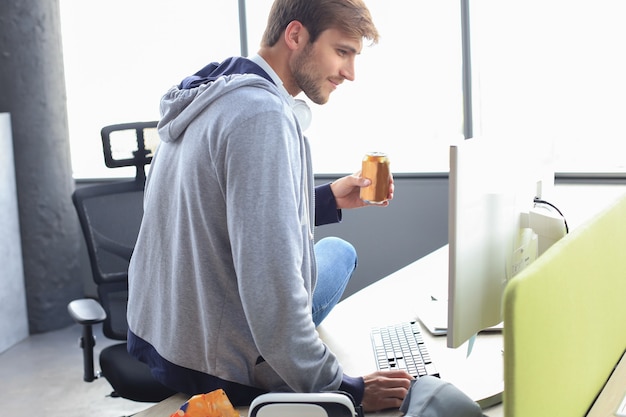 Photo gamer drinking an energy drink, concept of gaming lifestyle.