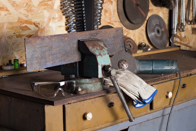 garage workshop with a master locksmiths workplace protective glasses gloves cutting machine